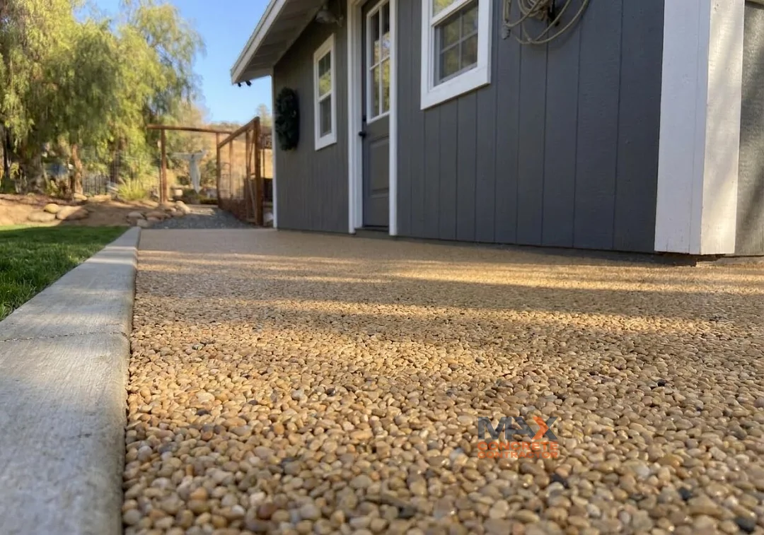 Close-up of sandy-toned resin bound surface texture near shed entrance in San Clemente, CA