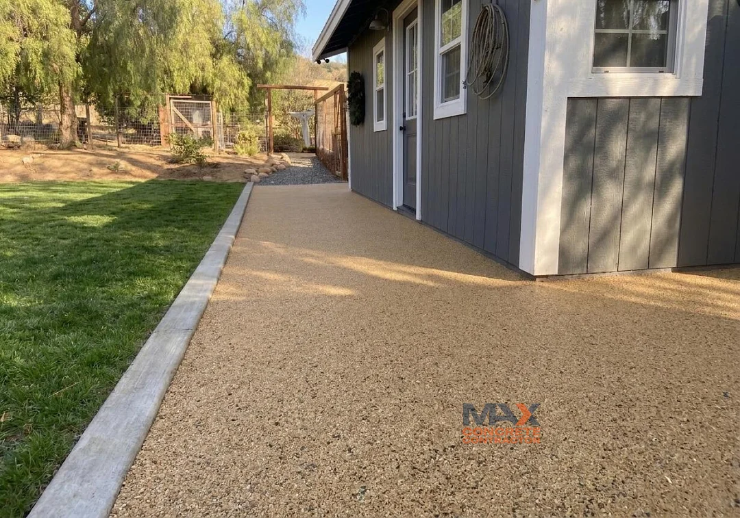 Resin bound walkway extending from lawn edge to fence line in San Clemente, CA backyard